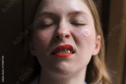 Portrait of unconventional woman with tooth stickers and red lips photo