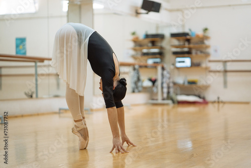 Woman in ballet costume dancing gracefully in studio photo