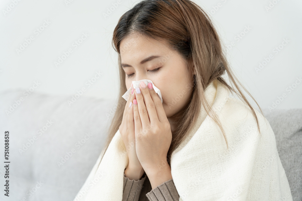 Pollen Allergies, asian young woman sneezing in a handkerchief or blowing in a wipe, allergic to wild spring flowers or blossoms during spring. allergic reaction, respiratory system problems Pollen Allergies, asian young woman sneezing in a handkerchief or blowing in a wipe, allergic to wild spring flowers or blossoms during spring. allergic reaction, respiratory system problems