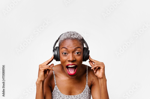 Horizontal portrait of woman listening to music in headphones photo