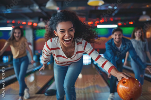 Group of young people having fun playing bowling photo