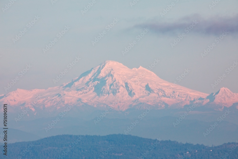 In the distance, the snow-capped summit of Mount Baker stands tall, shrouded in a pristine blanket of snow. 