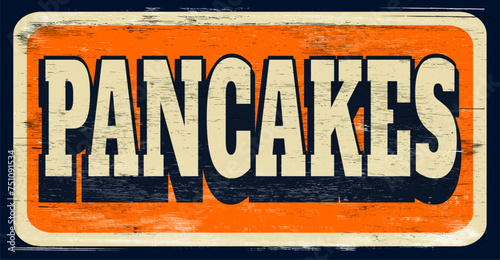 Aged retro pancakes sign on wood