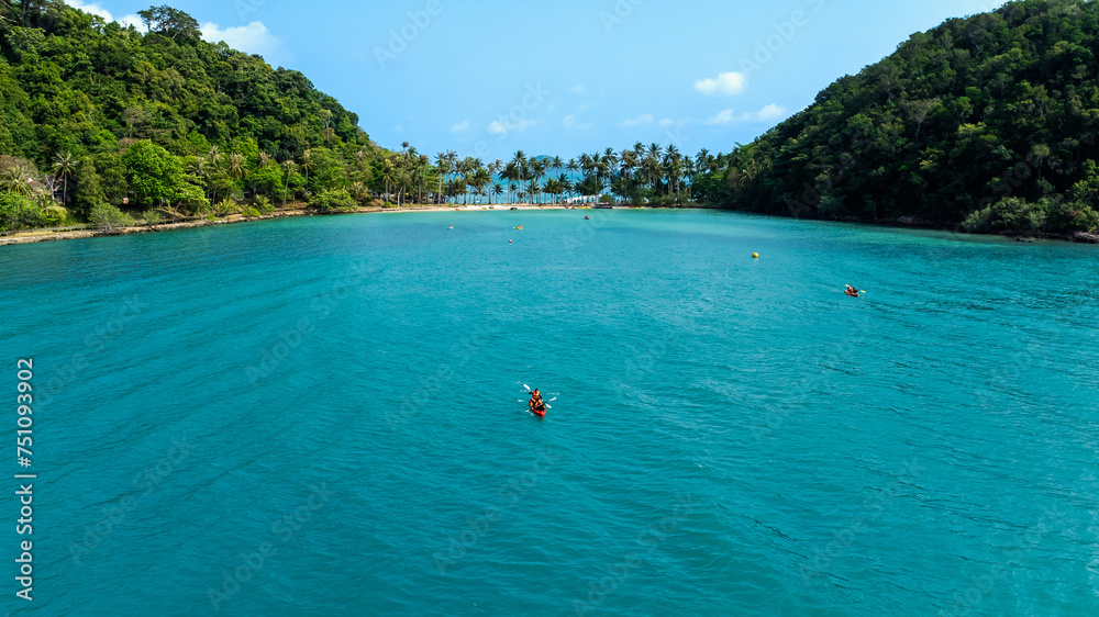 Travel vacation healthy lifestyle Concept. small happy tourist enjoy kayaking in sea, aerial view from drone,