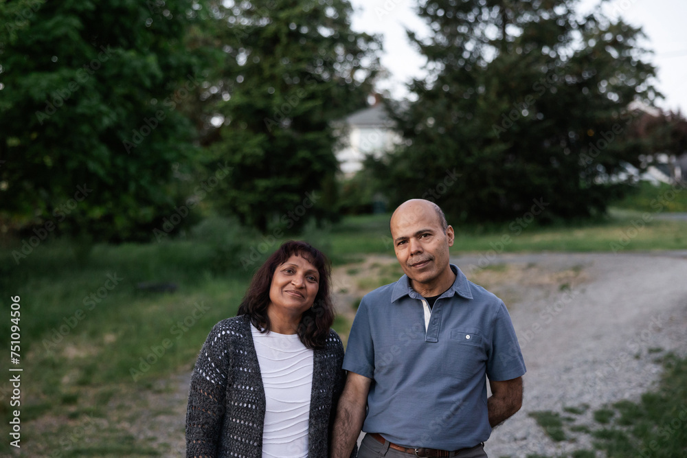 Simple portrait of mature couple outside standing on gravel road Simple portrait of mature couple outside standing on gravel road
