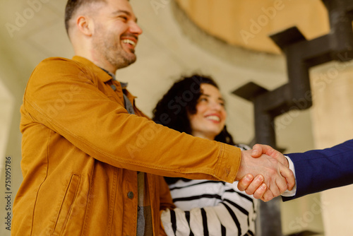 Real Estate Agent Congratulate Couple photo