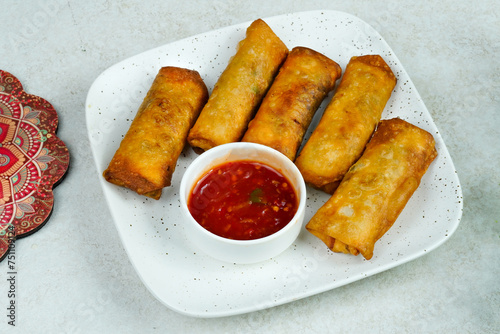 deep fried spring rolls. chicken rolls. samosa rolls photo