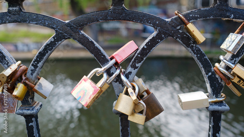 Love Padlocks on handrail by canal in London photo
