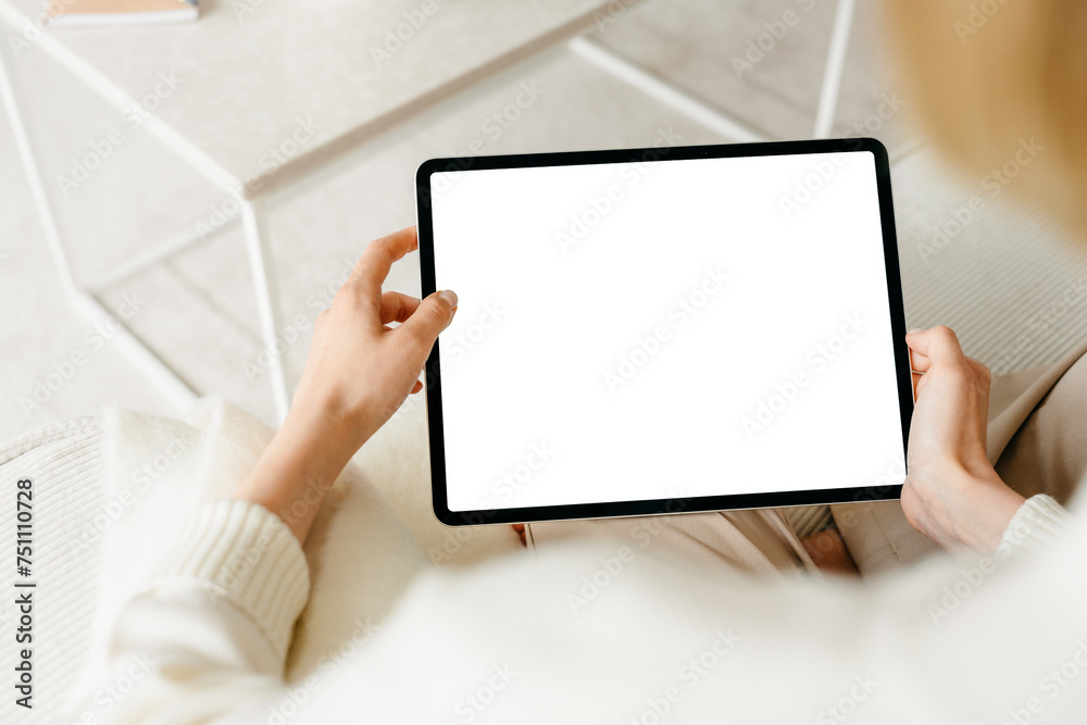 A tablet with a white screen in women's hands A tablet with a white screen in women's hands