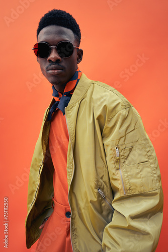 Black fashionable man model in stylish bomber jacket photo