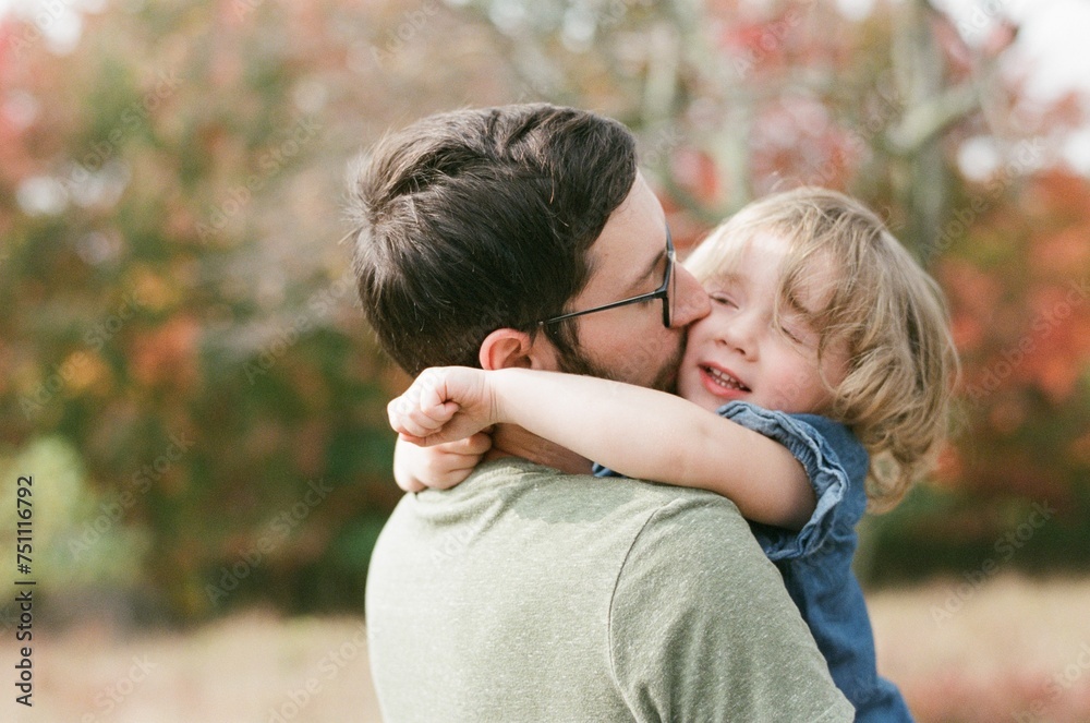 father hugging his toddler daughter