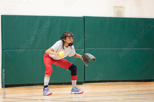 Child practicing proper ready position technique for softball photo