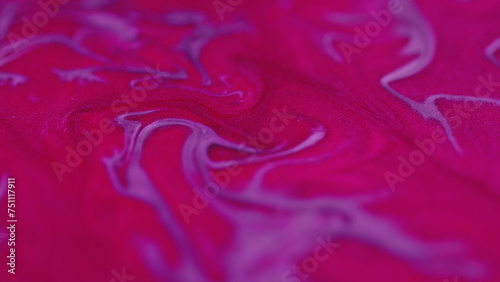 Glitter fluid. Sparkling ink mix. Defocused neon pink purple color shimmering particles texture paint flow motion art abstract background.
