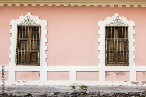 Pink house facade, with old windows of republican design photo