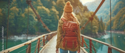 Walking along the picturesque bridge is a pretty young lady travelling with a rucksack.