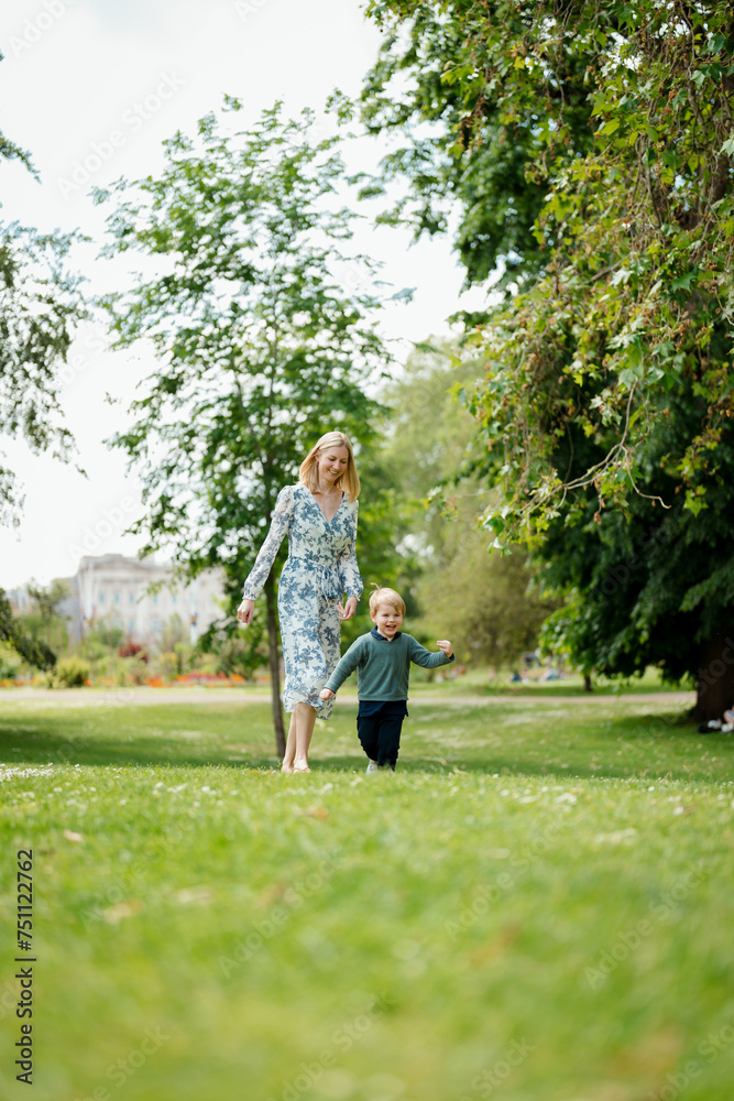 A mother walks with her son in the park