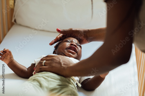 Woman Putting Crying Baby to Sleep photo