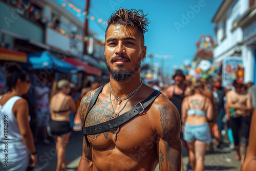 Sexy muscular latino gay man with bare abs in leather harness at the LGBT parade on the street © alexkoral
