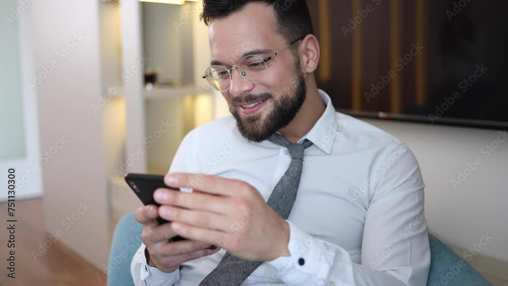 Young businessman using smartphone and laughing Young businessman using smartphone and laughing
