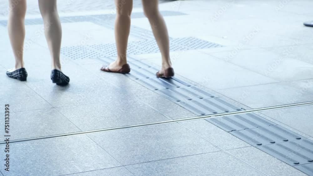 Two women leaveing the building and going through glass doors.