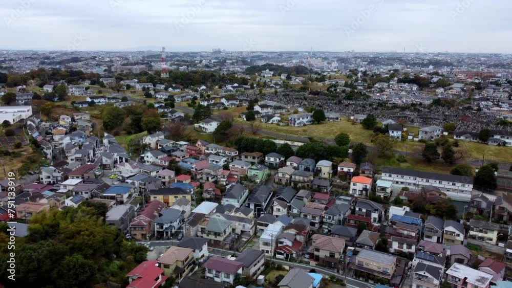 A dense residential area with a train passing through, daytime, aerial view A dense residential area with a train passing through, daytime, aerial view