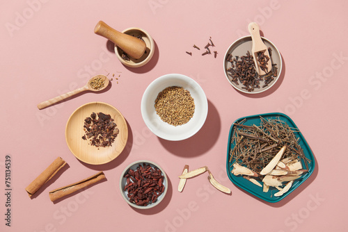 Whole dried cloves, cinnamon sticks and some herbal photo
