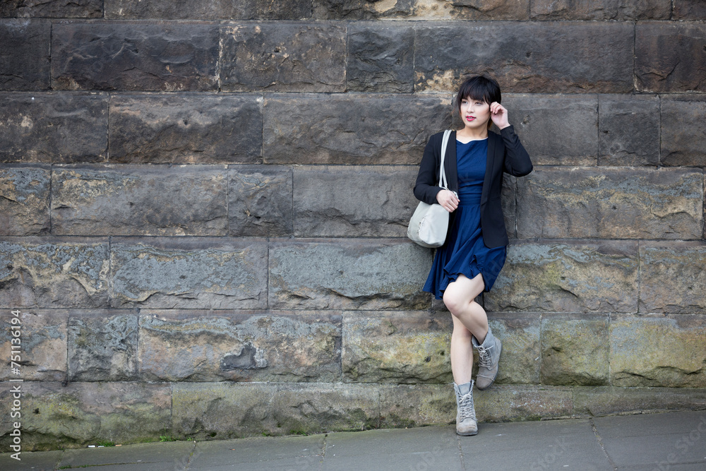 Portrait of a Asian woman leaning against a wall. Portrait of a Asian woman leaning against a wall.