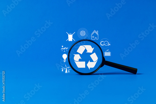 A magnifying glass showing a recycling symbol with a blue background. For expressing concepts related to the environment ecological conservation friendly to nature World waste management.