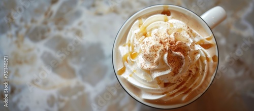 A top view showing a cup of freshly made caramel latte topped with a generous dollop of whipped cream, inviting and ready to be enjoyed.