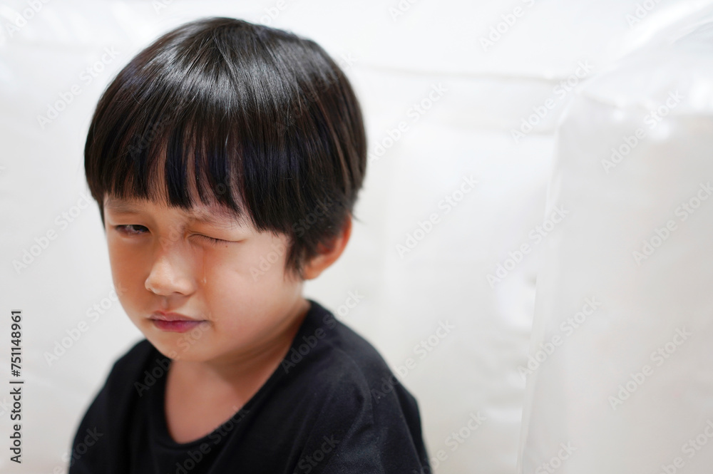 Close up Asian little boy, crying emotionally at home Close up Asian little boy, crying emotionally at home
