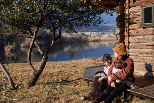 Asian mom with her kids on vacation by the highland lake photo