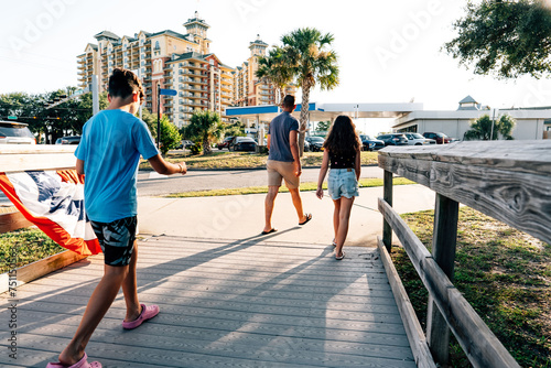 Family walking across a boardwalk. photo