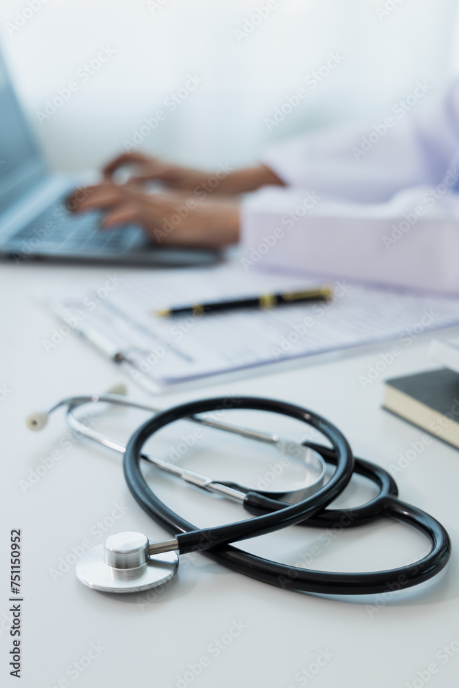 Female doctor works with her laptop computer in the doctor's office. Female doctor works with her laptop computer in the doctor's office.