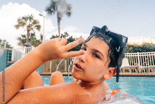 Teen boy showing the peace sign. 