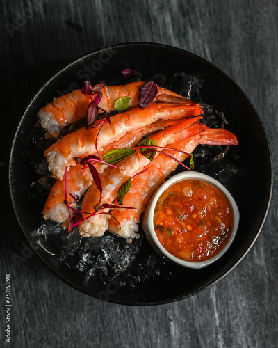 Plate with large prawns and sauce  photo