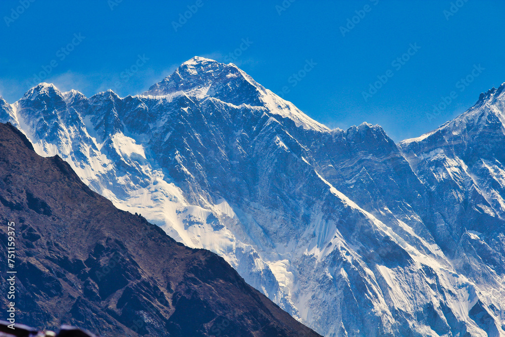 Everest Summit pyramid can be seen over the long Nuptse ridge line in this long range shot taken from Namche Bazaar,Nepal
