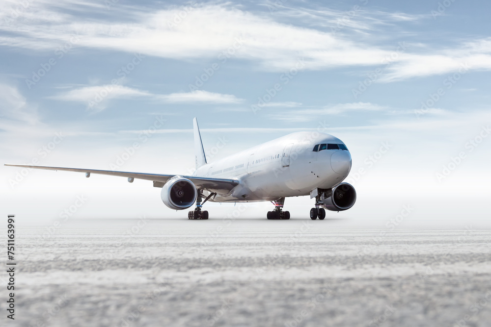 Obraz premium White wide body passenger airliner isolated on bright background with sky