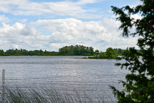 Idyllic Lake Asnen with small lakes, forested islands and grasses with trees and forest in the background in Asnen National Park, Urshult, Smaland, Sweden photo