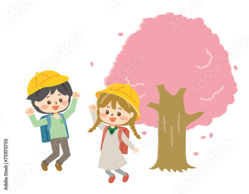桜の木の前で入学を喜ぶ男女の小学生