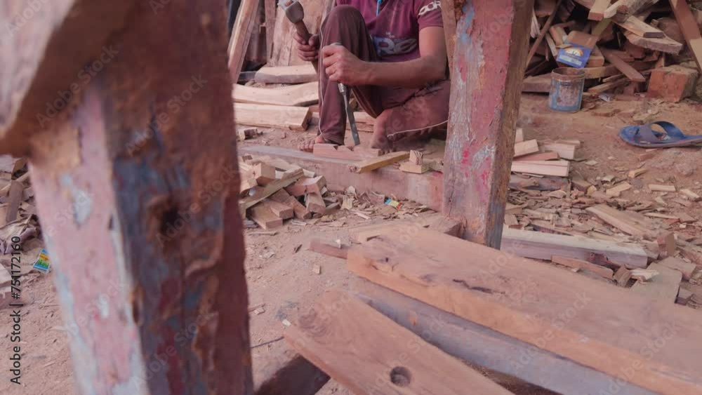 Carpenter working with wood in a rustic workshop focus on foreground with tools and timber Carpenter working with wood in a rustic workshop focus on foreground with tools and timber