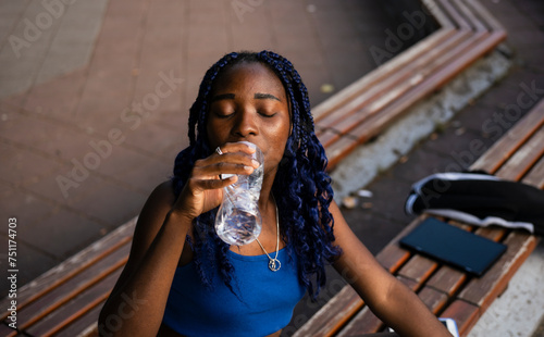 A young woman drinking water photo