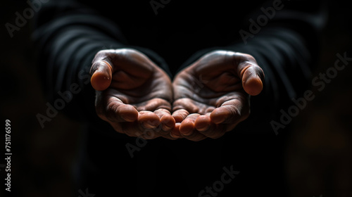 outstretched hands closeup black background © Olexandr