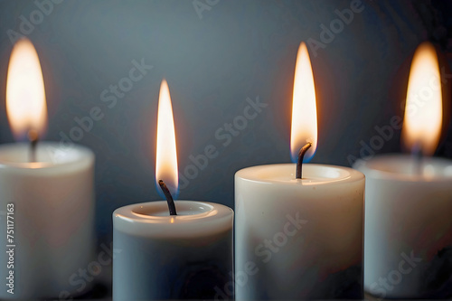 Close Up of Four Small Candles with a Black and Grey Background