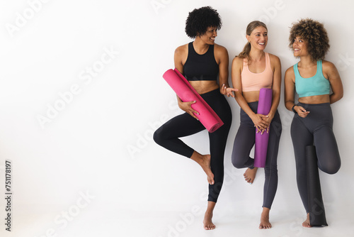 Diverse group of women ready for a yoga session with copy space