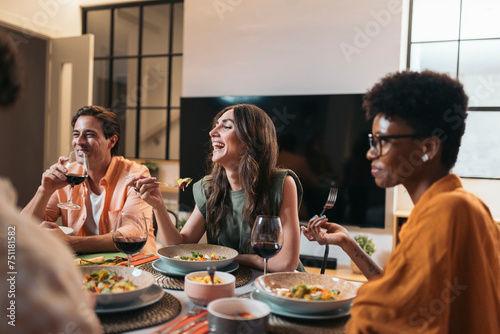 Diverse Friends Having Dinner at home While chatting photo
