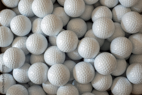 White golf balls ready for play or to practice the game of golf