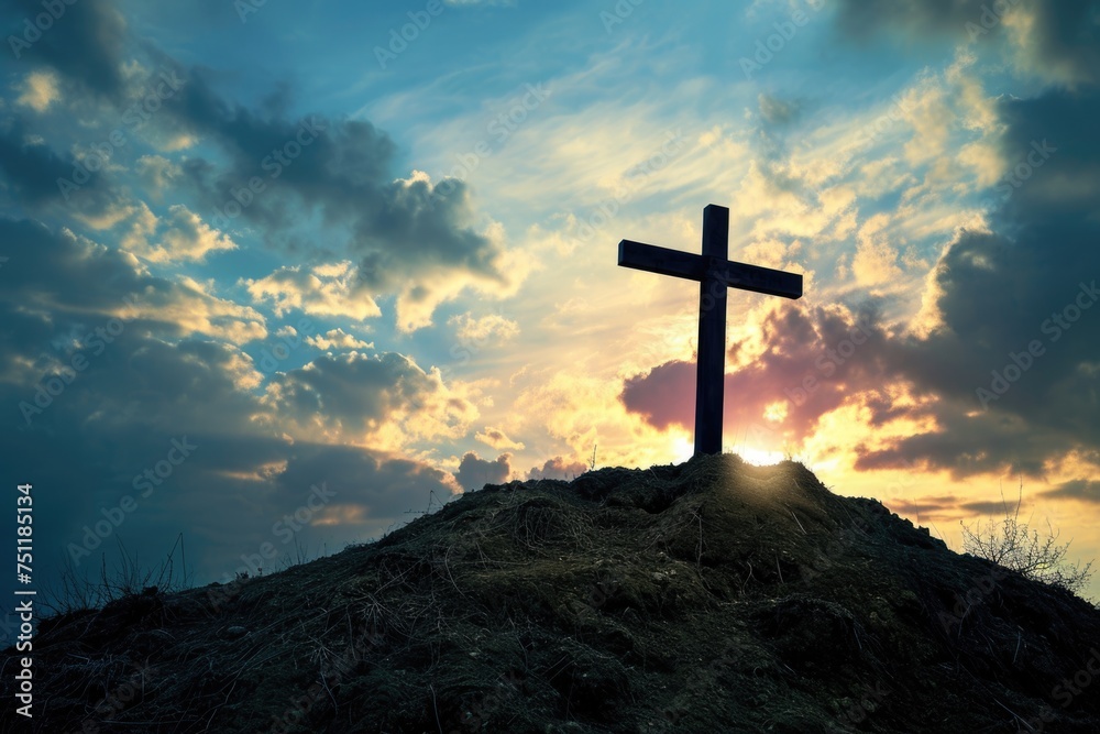 Wooden cross on a hill with dramatic sunset sky. - obrazy, fototapety, plakaty 
