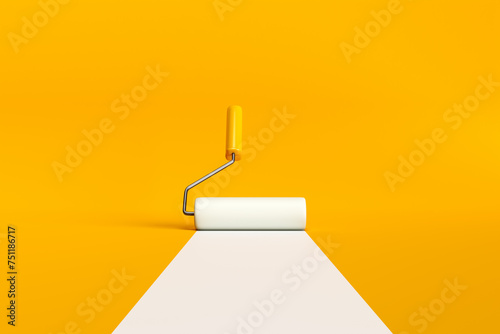 Paint roller brush painting a white line on yellow background.
