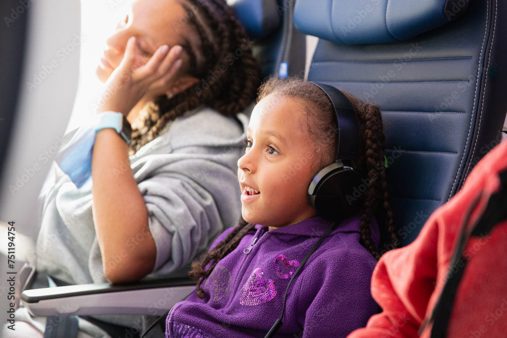© Anya Brewley Schultheiss/Stocksy - Closeup portrait of a child watching an inflight movie.