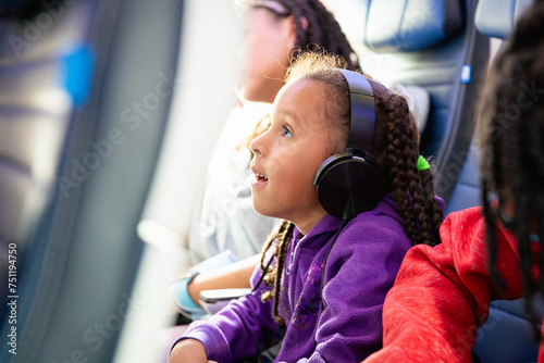 Closeup portrait of a child watching an inflight movie.  photo